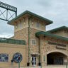 Ned Donovan stands in front of Constellation Field, home of the Sugar Land Space Cowboys, in Sugar Land TExas
